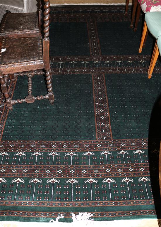 A Pakistan dark green Bokhara style carpet